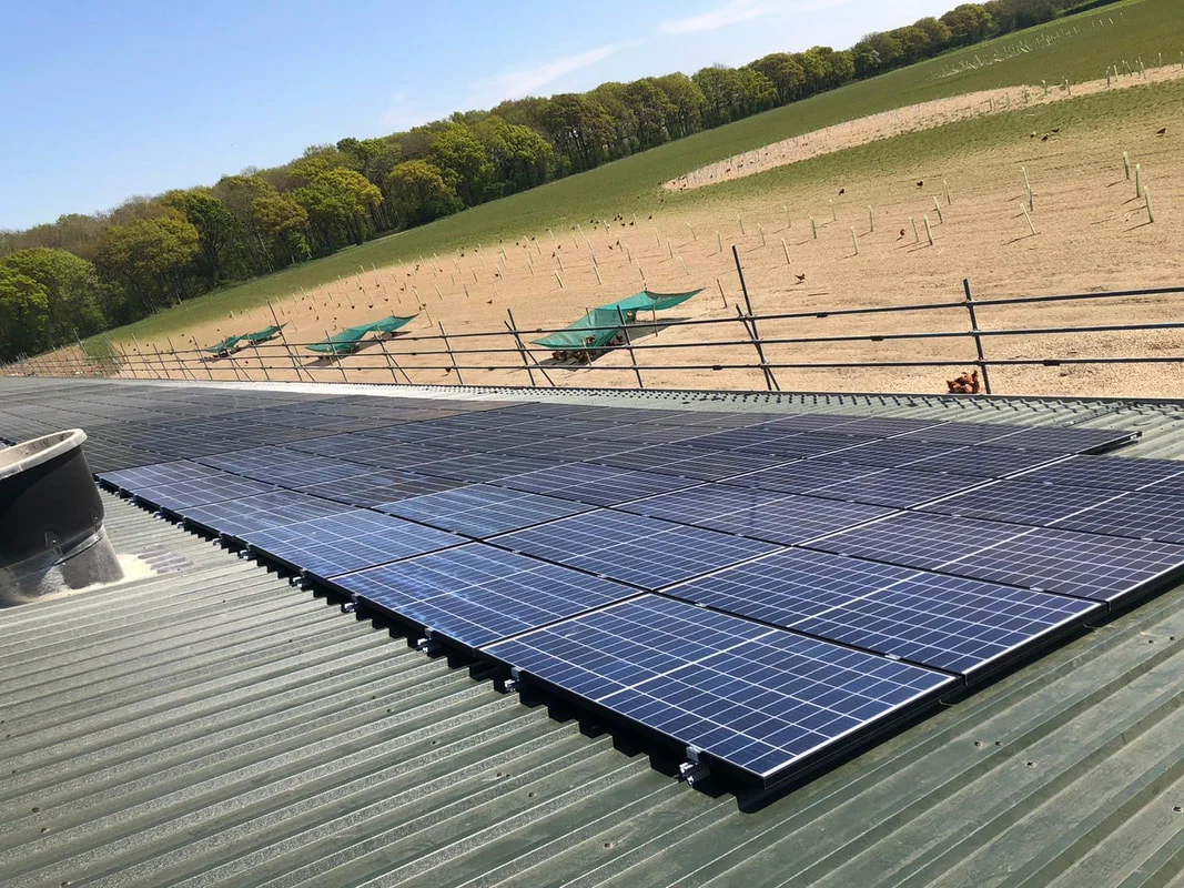 Solar PV panels installed on the profiled metal roof of a farm building