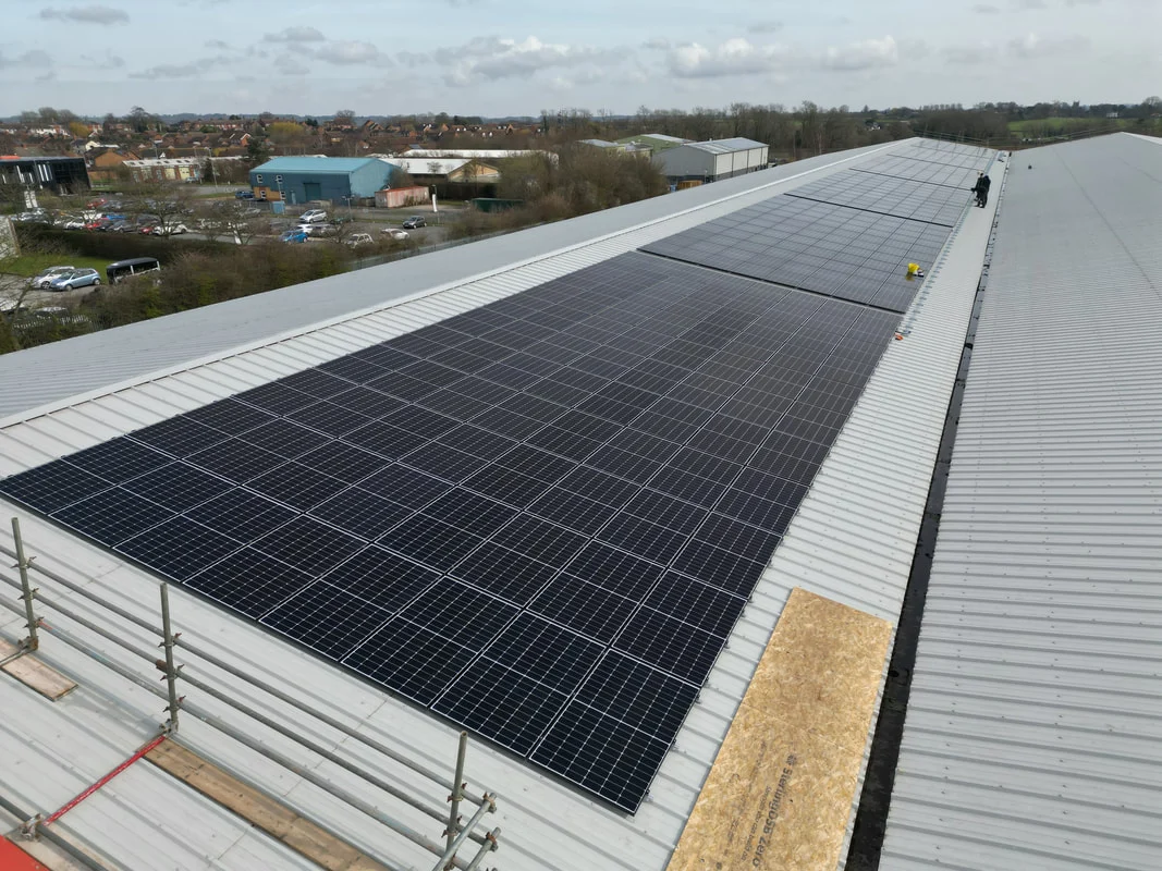 Solar PV panels installed along a commercial roof