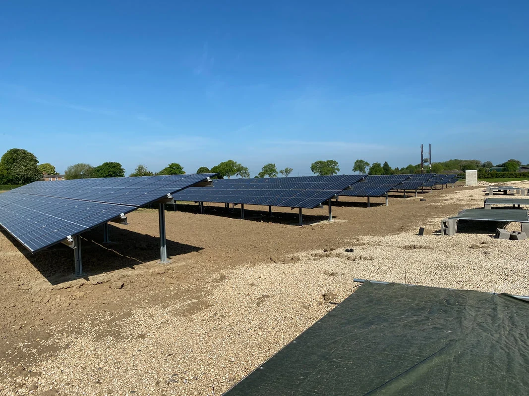 Rows of ground-mounted solar PV panels on a steel frame